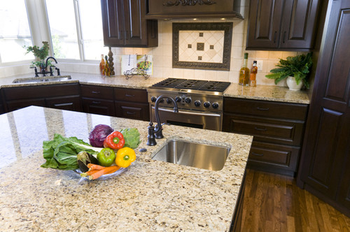 Giallo Napoli Countertop with Molasses Color Cabinets and Frost Glaze , Cream Tone Travertine Backpslash and Bronze Tile Border
